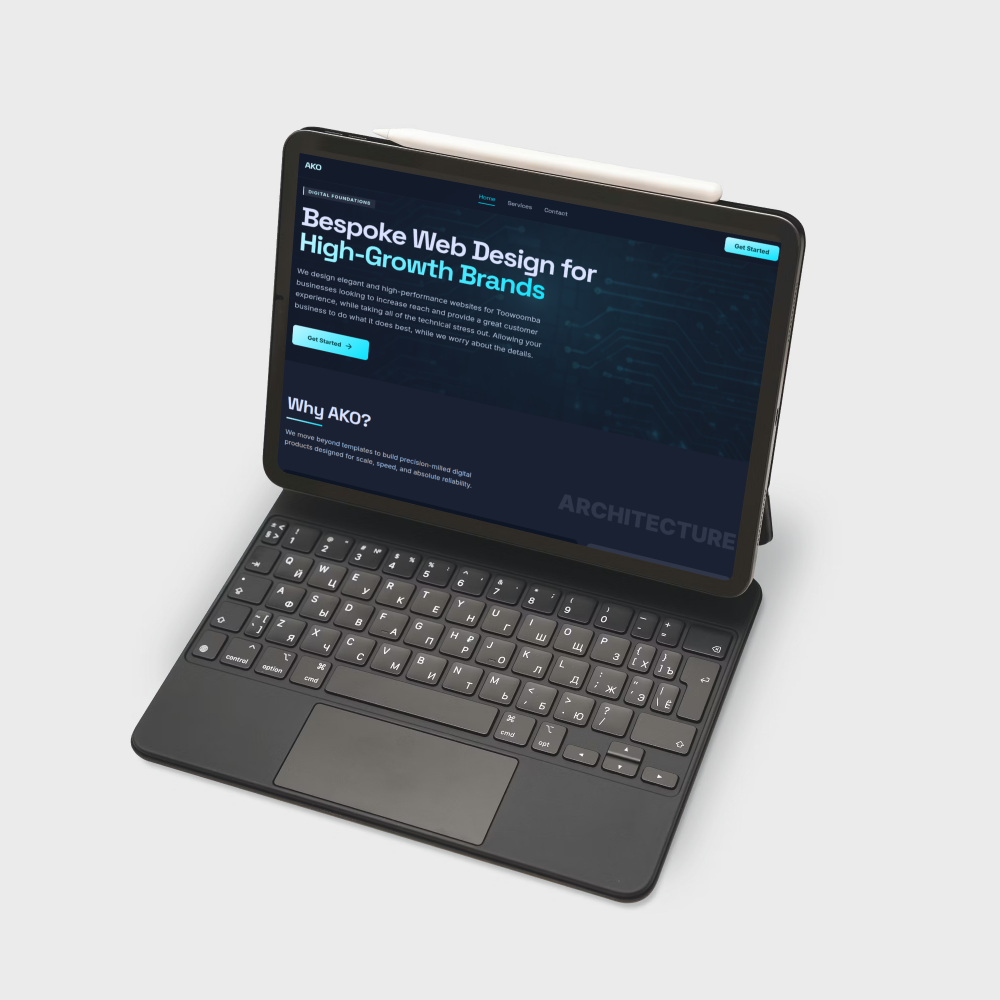 Close up of a premium laptop showing a beautifully designed architectural website with overlapping text elements and high-quality photography